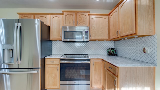 kitchen with light brown cabinetry, tasteful backsplash, and stainless steel appliances