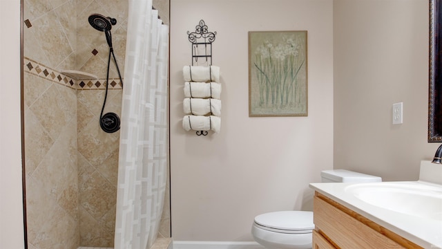 bathroom featuring vanity, toilet, and curtained shower