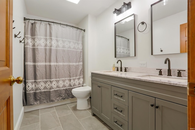 bathroom featuring vanity, toilet, and tile patterned flooring