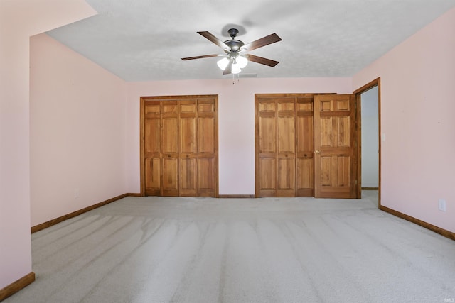 unfurnished bedroom featuring light carpet and ceiling fan