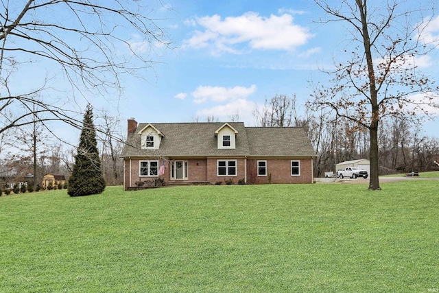 cape cod-style house featuring a front yard