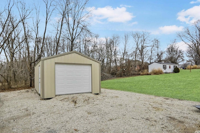 garage featuring a lawn