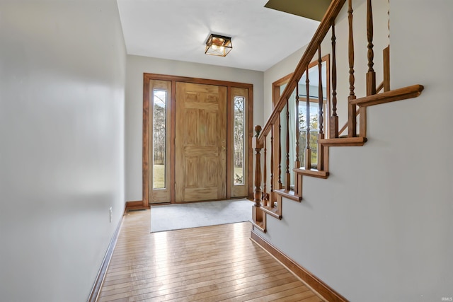 foyer with light hardwood / wood-style floors and a healthy amount of sunlight