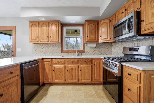 kitchen with stainless steel appliances, sink, and backsplash