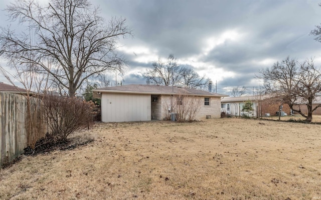 rear view of property with a lawn