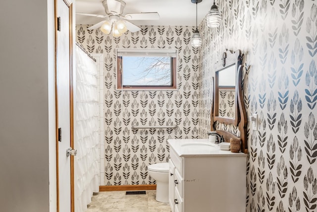 bathroom featuring ceiling fan, vanity, and toilet