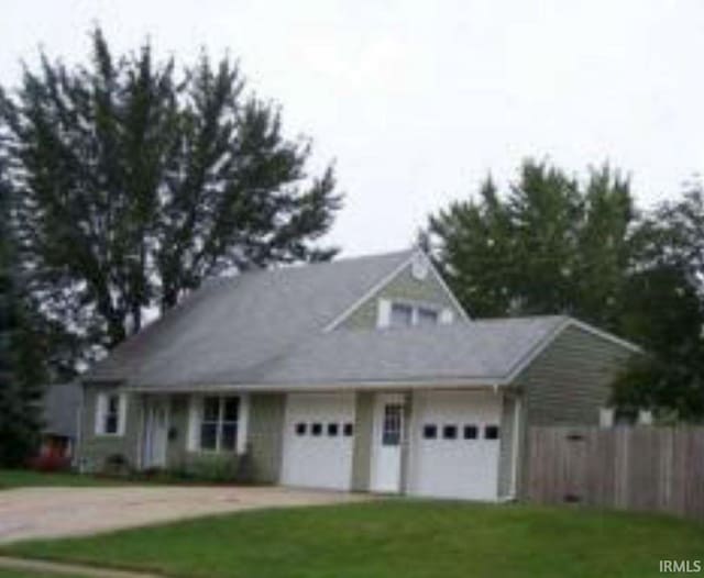 view of front of property featuring a garage and a front lawn