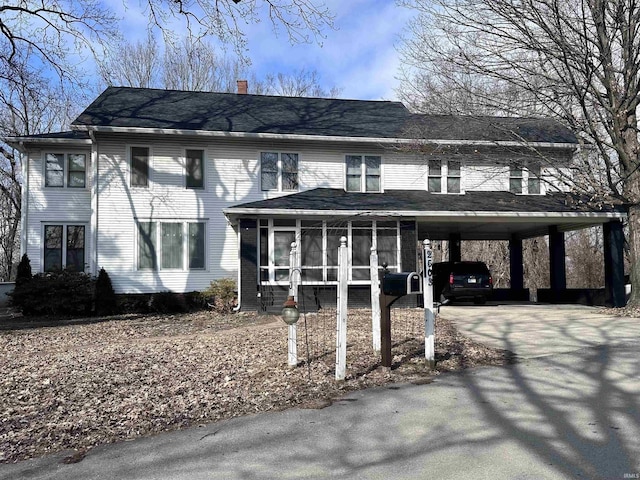 view of front of house featuring a carport and a sunroom