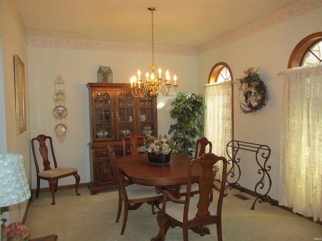 carpeted dining space with plenty of natural light and a notable chandelier