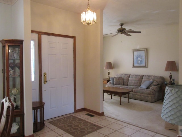 carpeted entryway featuring a chandelier