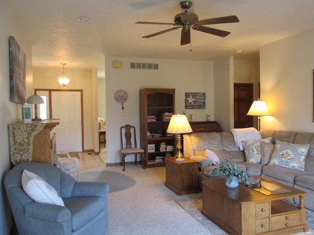 carpeted living room with ceiling fan