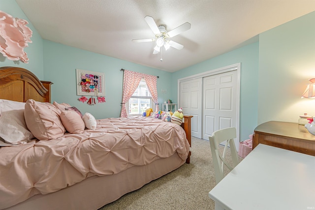 carpeted bedroom featuring a textured ceiling, a closet, and ceiling fan