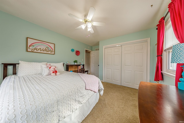 carpeted bedroom featuring ceiling fan and a closet