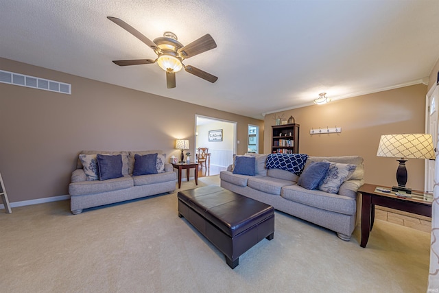 carpeted living room with ceiling fan and a textured ceiling