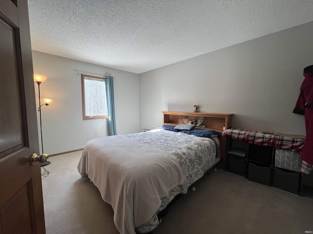 carpeted bedroom featuring a textured ceiling