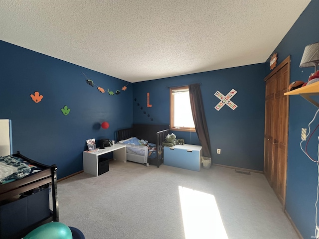 carpeted bedroom with a textured ceiling