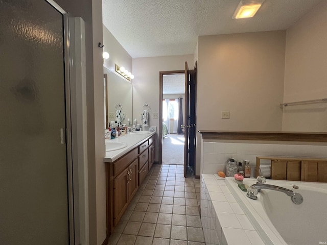 bathroom with vanity, tile patterned floors, a textured ceiling, and separate shower and tub