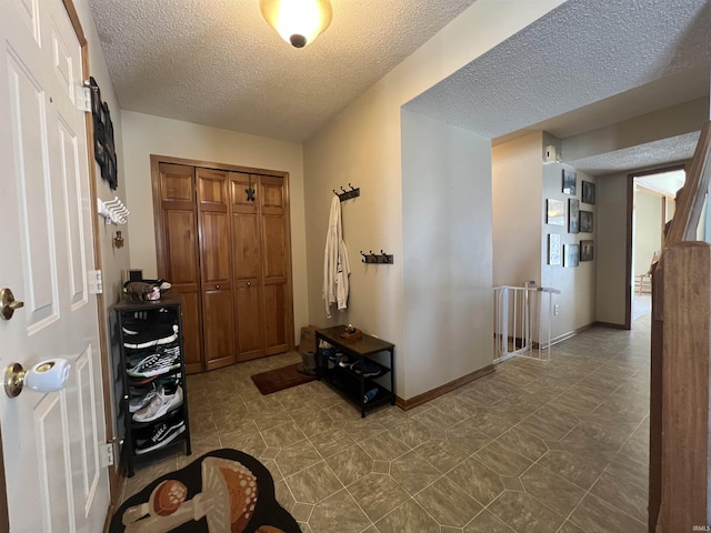 entryway with a textured ceiling