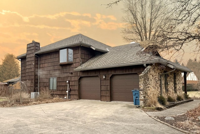 property exterior at dusk featuring a garage