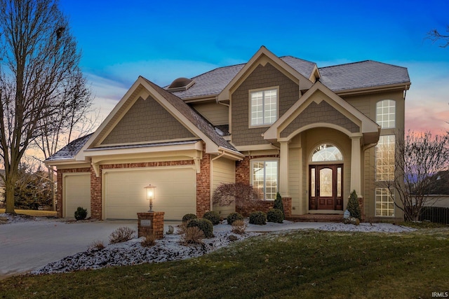 craftsman-style house with a yard and a garage