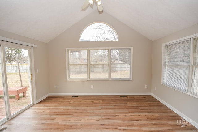 empty room with ceiling fan, a healthy amount of sunlight, and light wood-type flooring