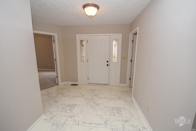 entrance foyer with a textured ceiling