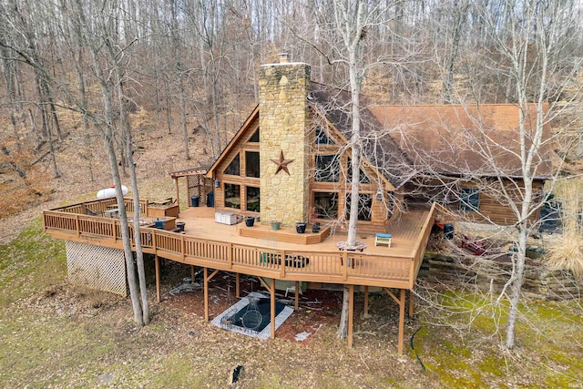 rear view of house featuring a wooden deck