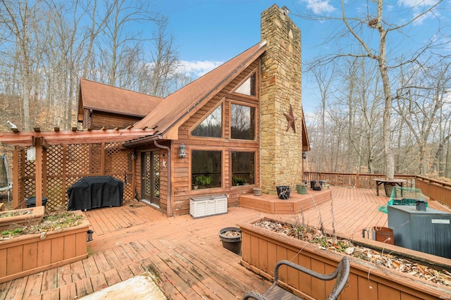 deck featuring area for grilling and a fire pit