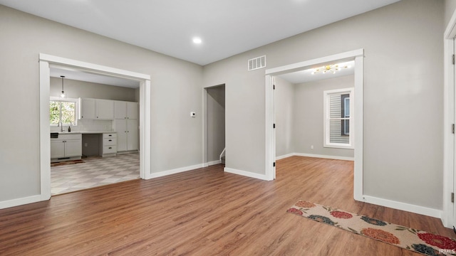 empty room featuring sink and light wood-type flooring