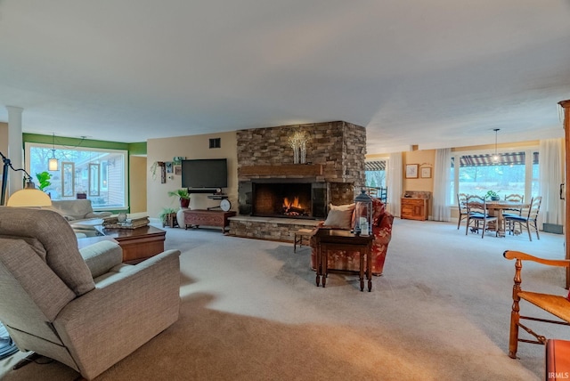 living room with light colored carpet and a fireplace