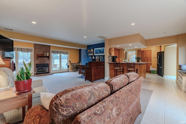 tiled living room with a brick fireplace