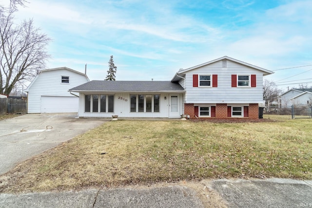 split level home featuring a garage and a front lawn