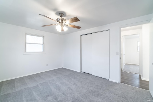 unfurnished bedroom with ceiling fan, carpet floors, and a closet