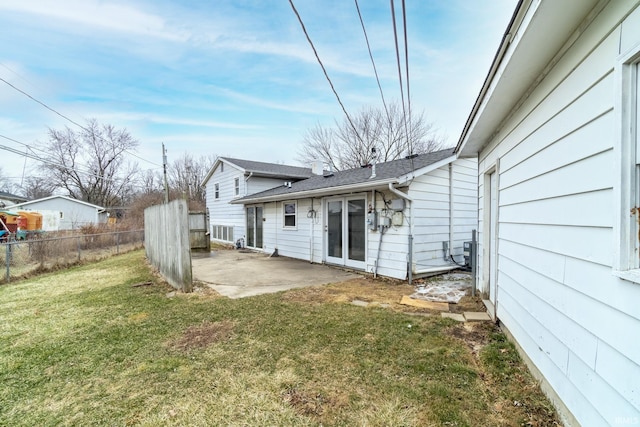 rear view of property with a yard and a patio area