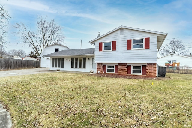 tri-level home with a front lawn