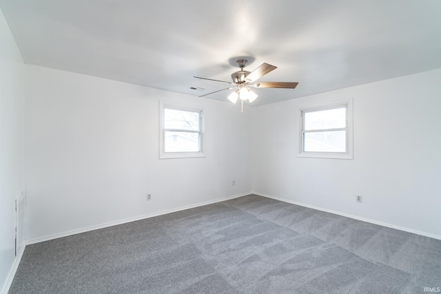 spare room with carpet flooring and ceiling fan