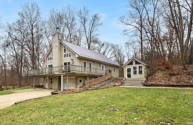 exterior space with a garage, a deck, and a front lawn