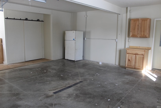 garage with white refrigerator