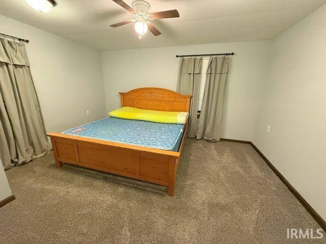 bedroom with ceiling fan and carpet flooring