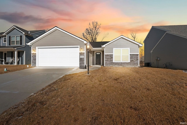 view of front of home featuring a garage, central AC unit, and a lawn