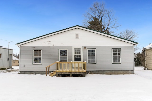 view of snow covered rear of property