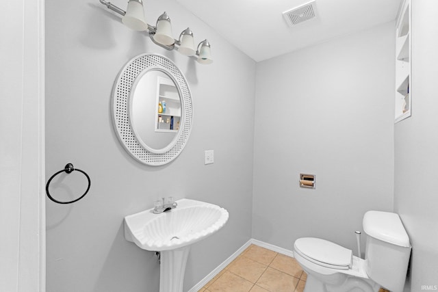 bathroom featuring sink, tile patterned floors, and toilet