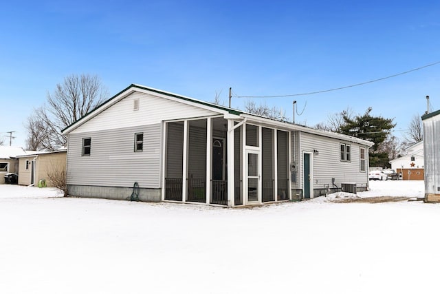 view of snow covered rear of property