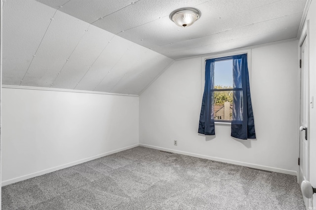 bonus room featuring lofted ceiling and carpet flooring