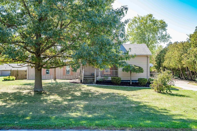 obstructed view of property featuring a front lawn