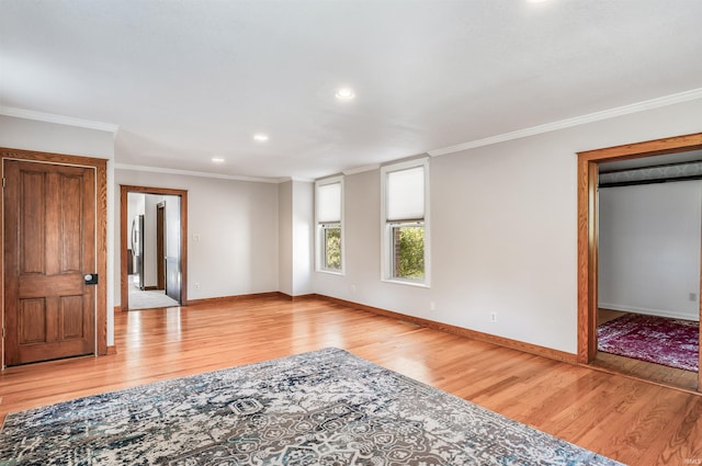 spare room with crown molding and light hardwood / wood-style floors