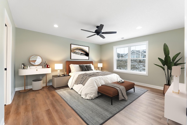 bedroom with ceiling fan and light hardwood / wood-style floors