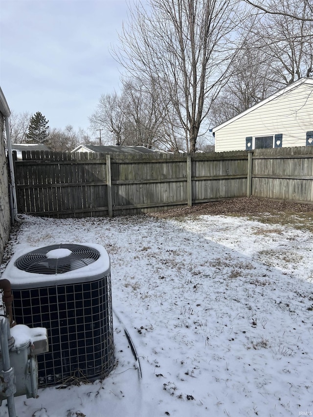 yard layered in snow with cooling unit