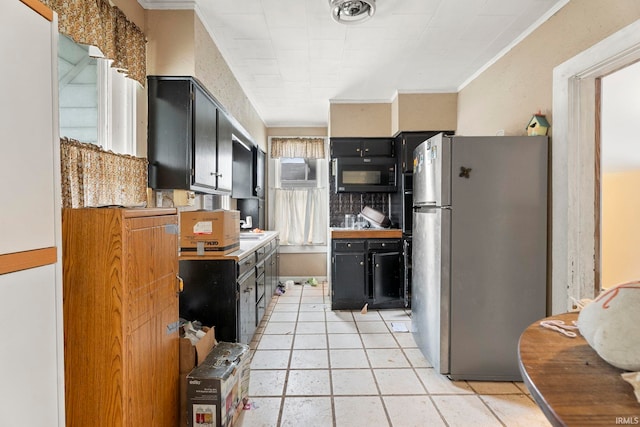 kitchen featuring light tile patterned floors, crown molding, stainless steel refrigerator, and a wall mounted AC