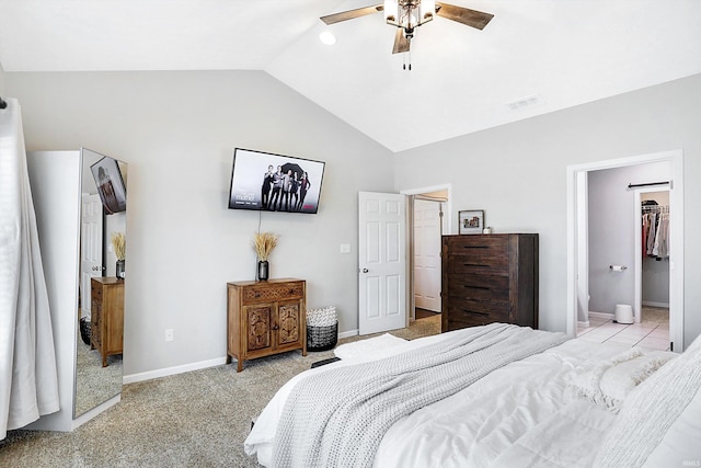 carpeted bedroom featuring ceiling fan, a walk in closet, and lofted ceiling